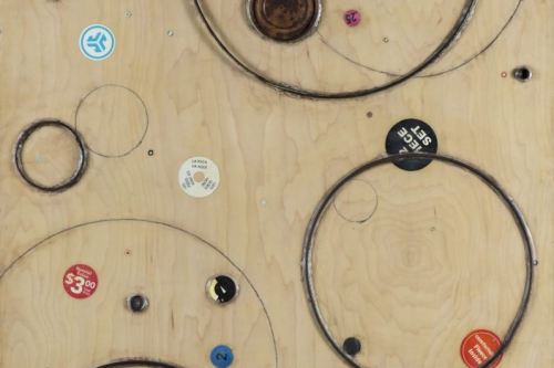 "Roundness" 2019, Acrylic, charcoal, paper, stickers, plastic, and metal collage on wood, 36 by 24 inches
