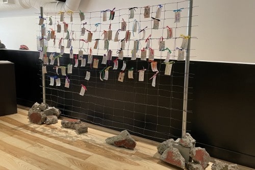 Messages of Hope and  Resistance, 2025, Metal, fence, rocks, cement, canvas, ribbon, ink, and wire,  72 by 96 by 12 inches