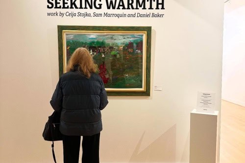 A visitor looks at a Ceija Stojka painting in the gallery, photo by Sharon Svec.
