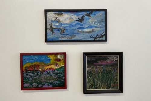 Ceija Stojka's paintings hanging on the gallery wall.