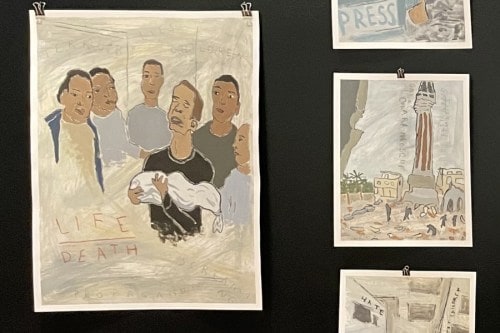 Sam Marroquin's paintings hanging on a black gallery wall.