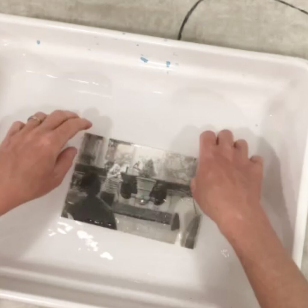 Hands in water bath with waterslide transfer